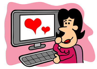 Kobieta siedząca przed komputerem i patrząca w ekran, na którym są dwa serca